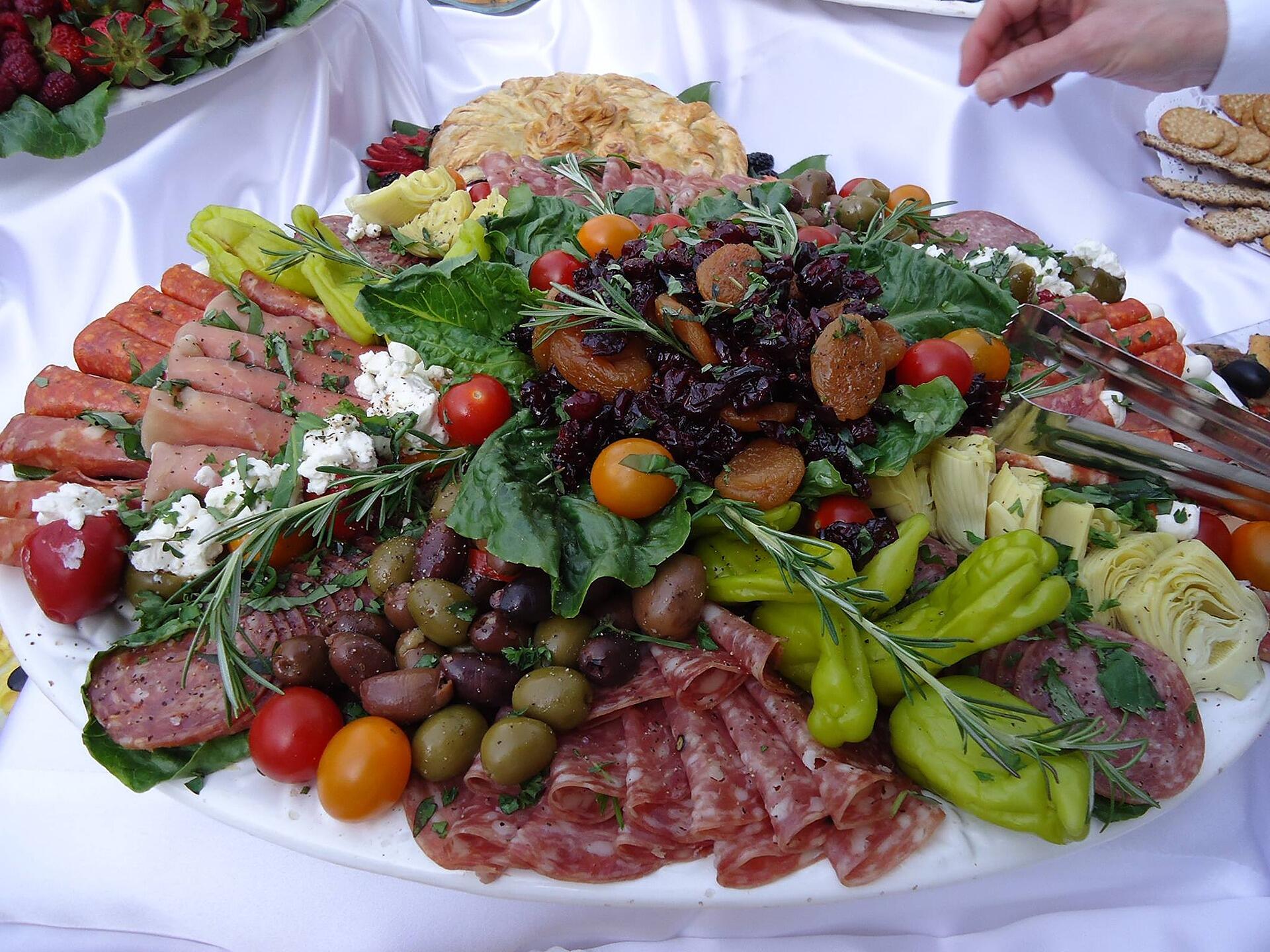 A custom prepared catered meat, vegetable, and cheese tray